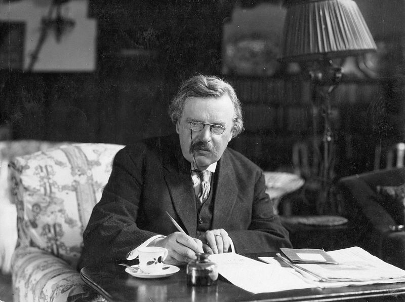 Photograph of Chesterton at his desk.